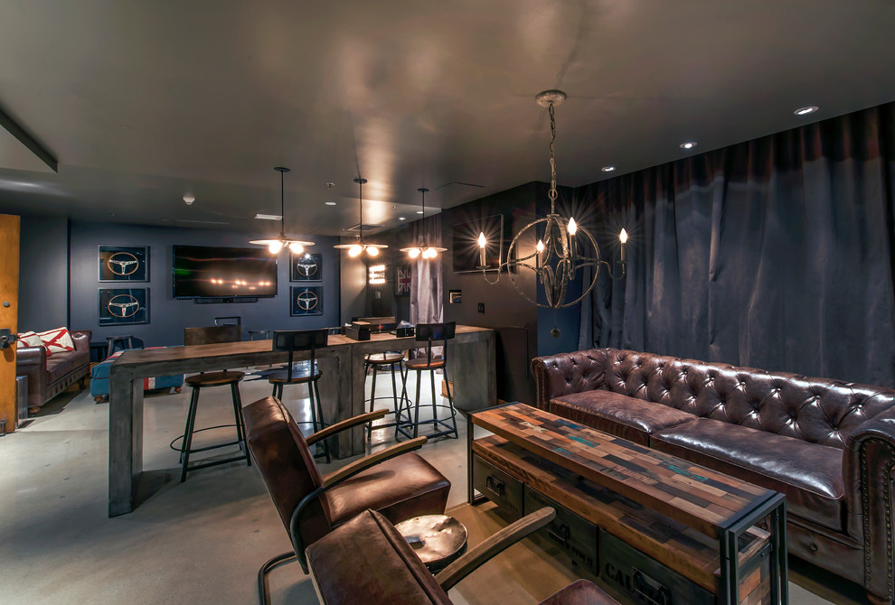 На фото: большая открытая гостиная комната в стиле лофт с домашним баром, синими стенами, бетонным полом, телевизором на стене и серым полом с