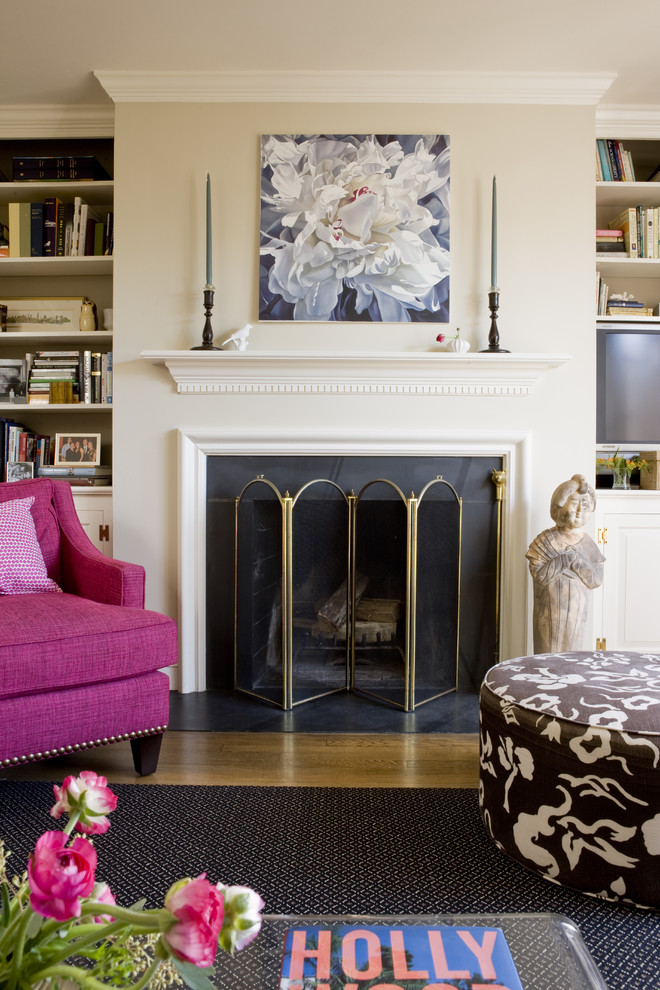 Family room - transitional medium tone wood floor family room idea in DC Metro with beige walls and a standard fireplace