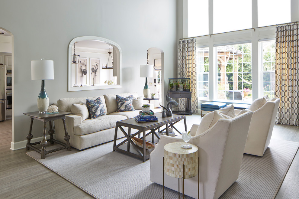 Идея дизайна: большая открытая гостиная комната в стиле неоклассика (современная классика) с серыми стенами, полом из винила, угловым камином, фасадом камина из дерева, телевизором на стене и серым полом