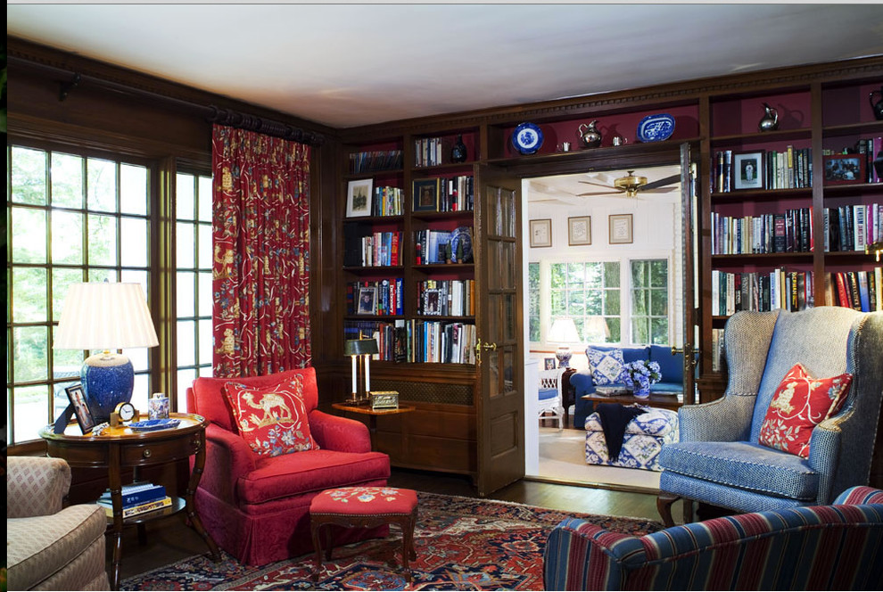Inspiration for a small timeless enclosed dark wood floor family room library remodel in Other with a standard fireplace, no tv and orange walls