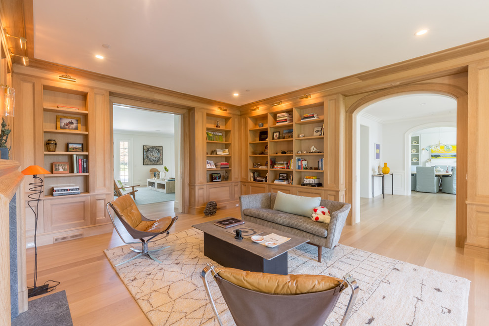 Ejemplo de sala de estar con biblioteca abierta clásica renovada grande con todas las chimeneas y alfombra