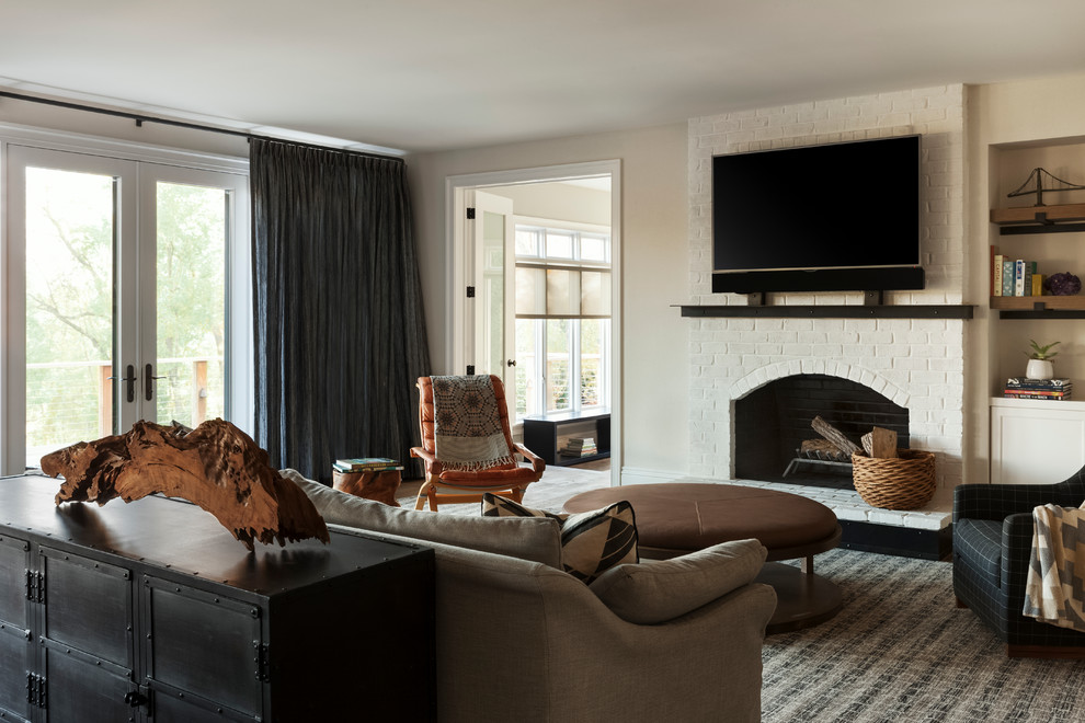 Идея дизайна: огромная изолированная гостиная комната в стиле неоклассика (современная классика) с бежевыми стенами, ковровым покрытием, стандартным камином, фасадом камина из кирпича и телевизором на стене