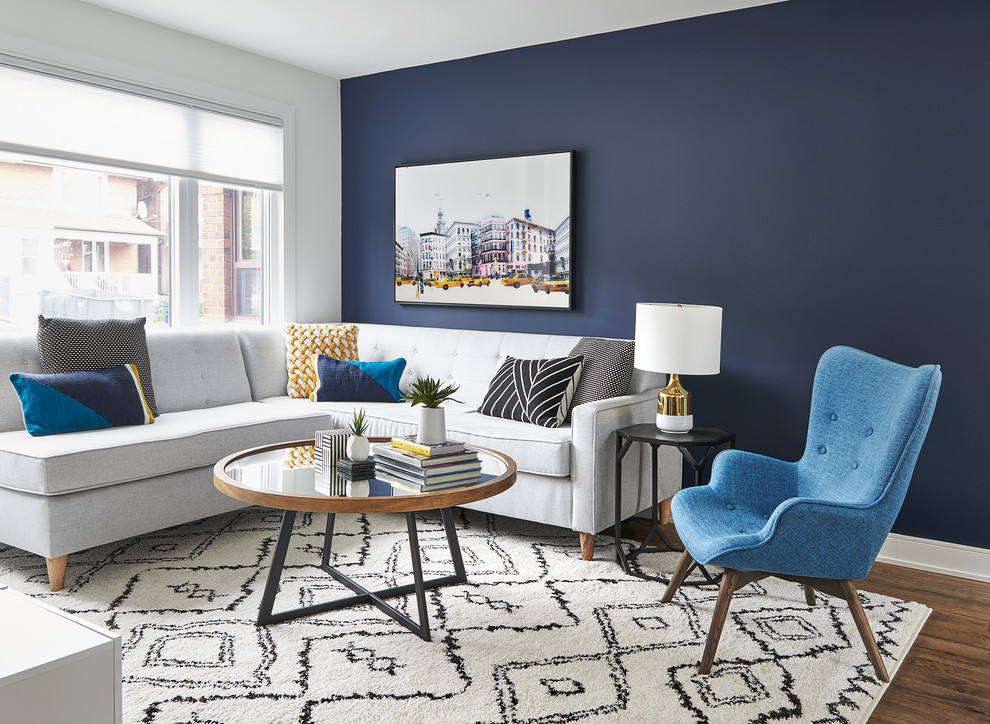 Inspiration for a mid-sized contemporary open concept medium tone wood floor family room remodel in Toronto with no fireplace and blue walls