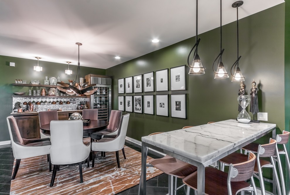 Expansive modern open plan games room in Omaha with green walls, travertine flooring, a standard fireplace, a brick fireplace surround, a game room and a freestanding tv.