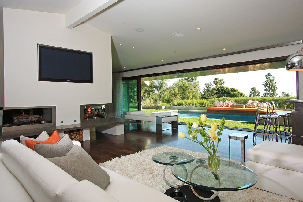 Family room - contemporary family room idea in Los Angeles with a corner fireplace