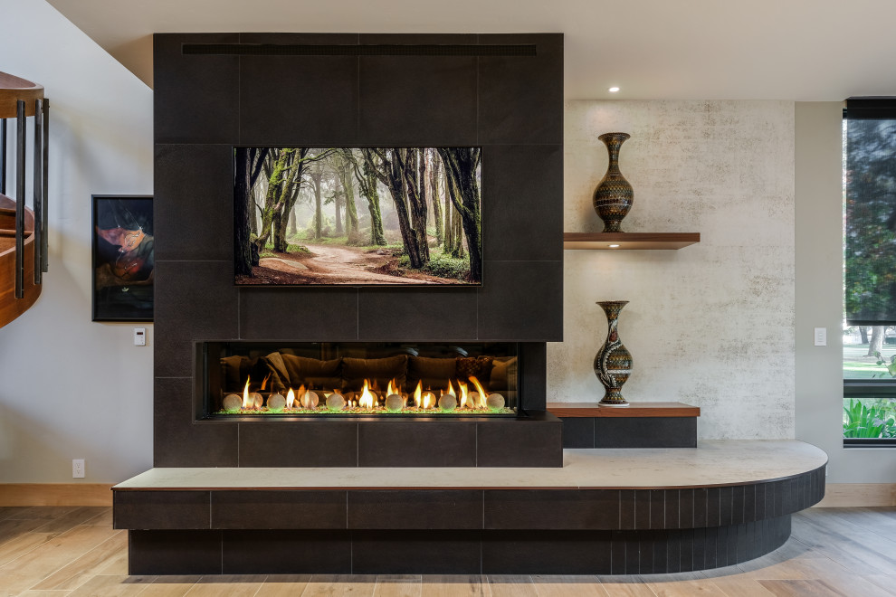 Inspiration for a large contemporary open concept porcelain tile, beige floor and vaulted ceiling family room remodel in Sacramento with white walls, a tile fireplace and a wall-mounted tv