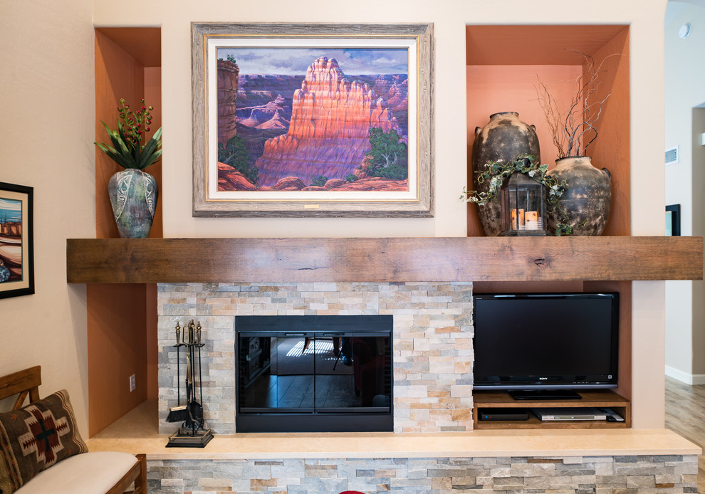Example of a mid-sized mountain style enclosed porcelain tile and beige floor family room design in Minneapolis with beige walls, a standard fireplace, a stone fireplace and a tv stand