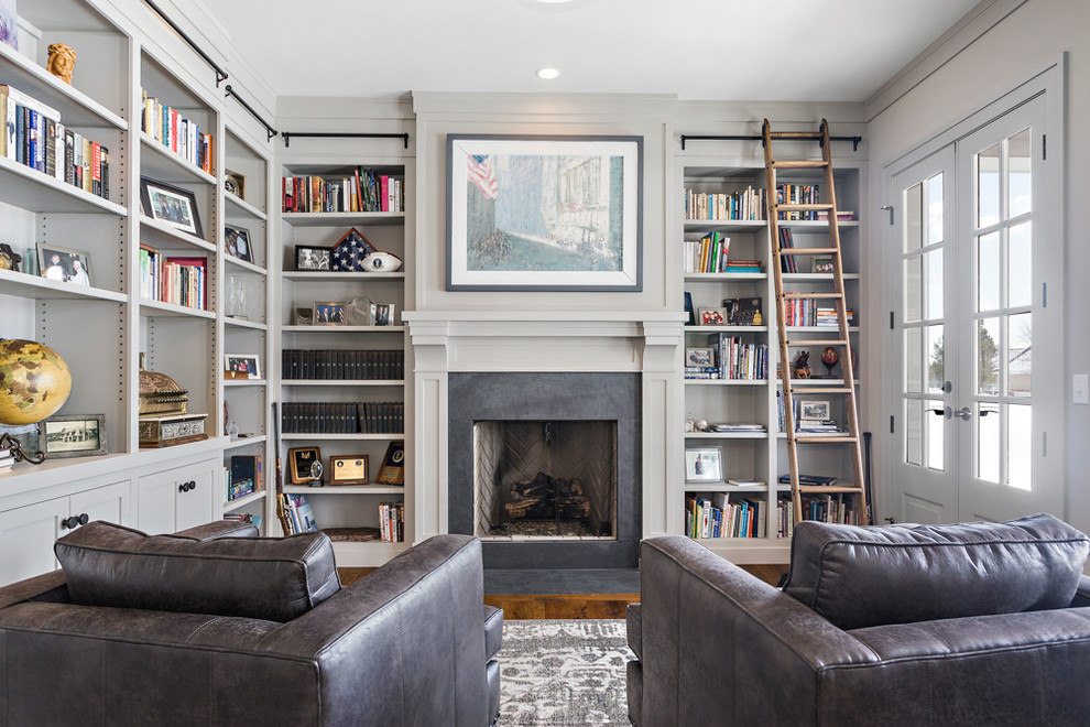 Example of a classic enclosed dark wood floor family room library design in Other with gray walls, a standard fireplace and no tv