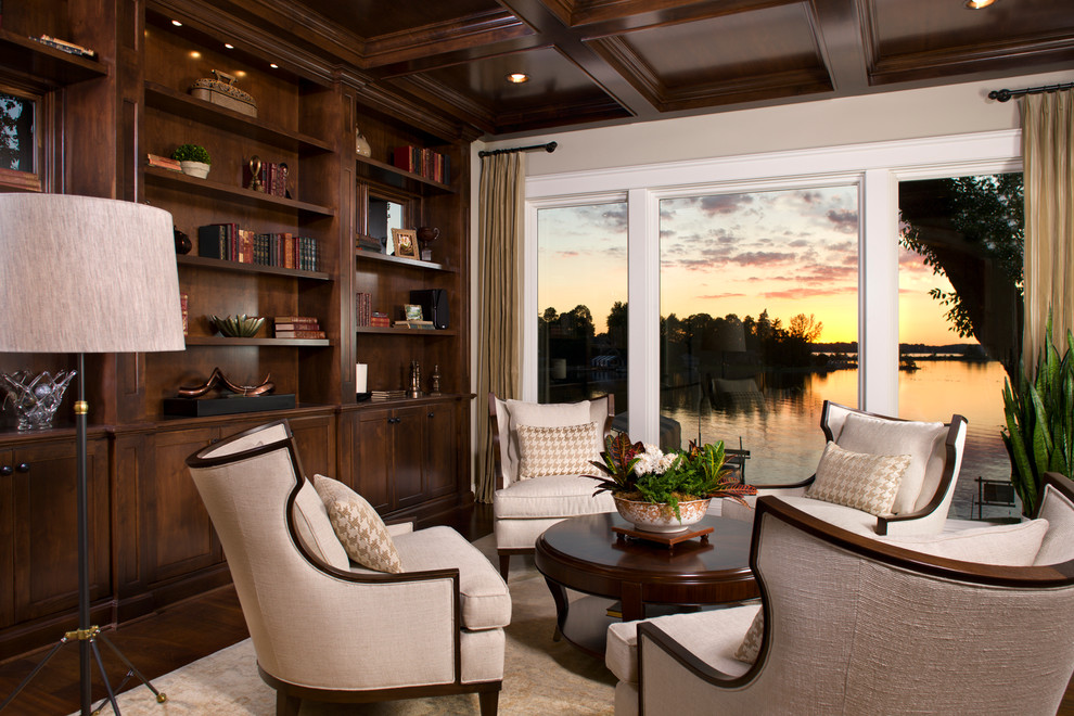 Foto de sala de estar con biblioteca cerrada contemporánea de tamaño medio sin chimenea y televisor con paredes beige, suelo de madera oscura y suelo marrón