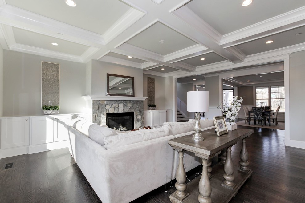 Large traditional open plan games room in DC Metro with grey walls, dark hardwood flooring, a standard fireplace and a stone fireplace surround.