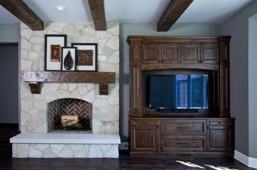 Large classic open plan games room in Chicago with grey walls, dark hardwood flooring, a standard fireplace, a stone fireplace surround and a built-in media unit.