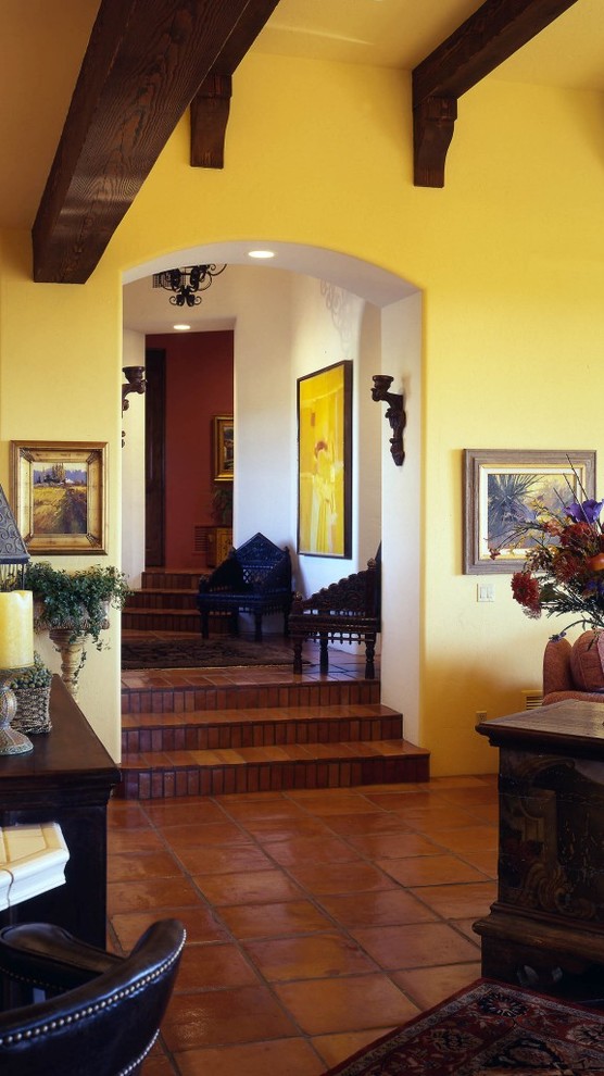 Immagine di un soggiorno american style di medie dimensioni e aperto con sala giochi, pareti gialle e pavimento in terracotta