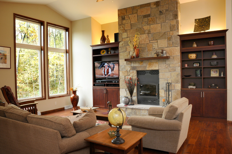 Family room - traditional open concept medium tone wood floor family room idea in Other with a standard fireplace, a stone fireplace and a tv stand