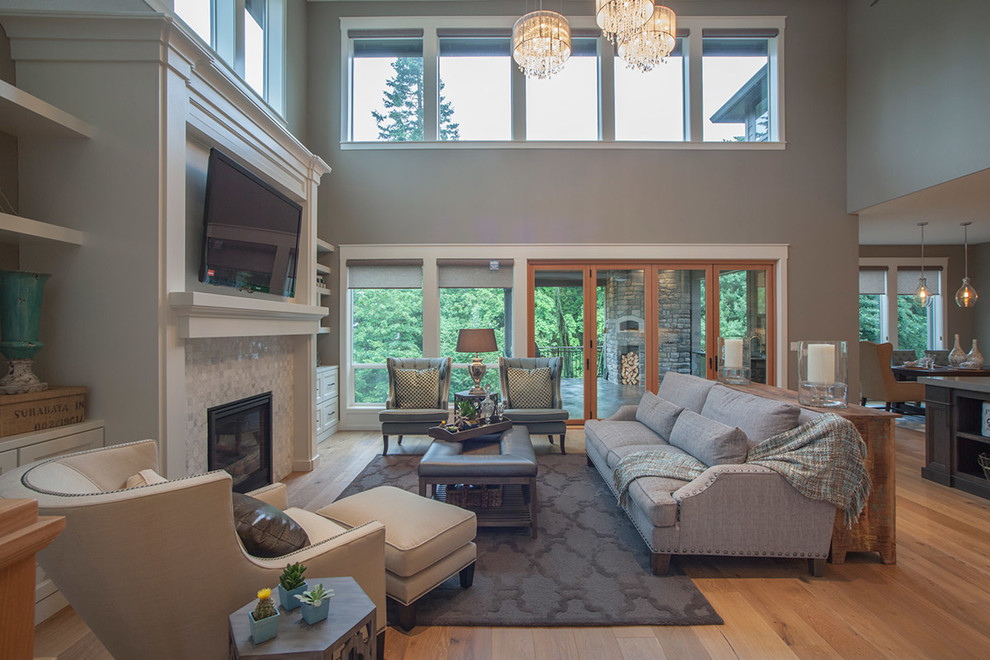 Expansive classic open plan games room in Portland with a reading nook, grey walls, light hardwood flooring, a standard fireplace, a built-in media unit and a tiled fireplace surround.