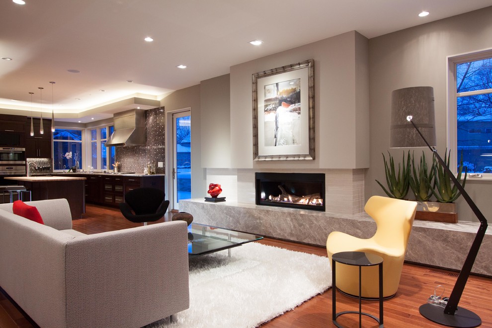 This is an example of a large contemporary open plan games room in Cleveland with grey walls, dark hardwood flooring, a ribbon fireplace, a plastered fireplace surround and no tv.