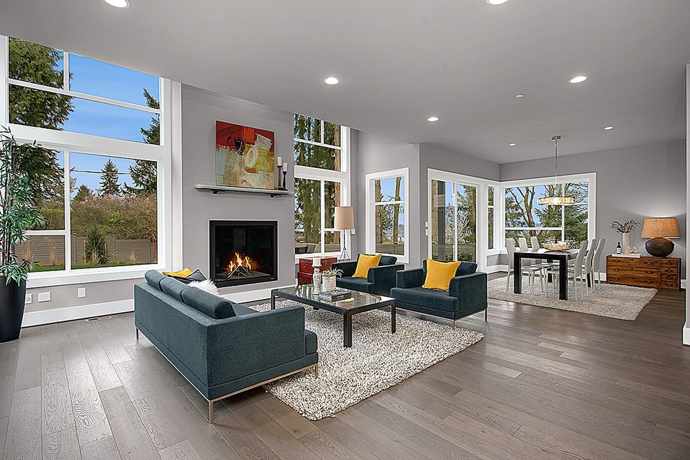Family room - modern open concept dark wood floor family room idea in Seattle with gray walls and a standard fireplace