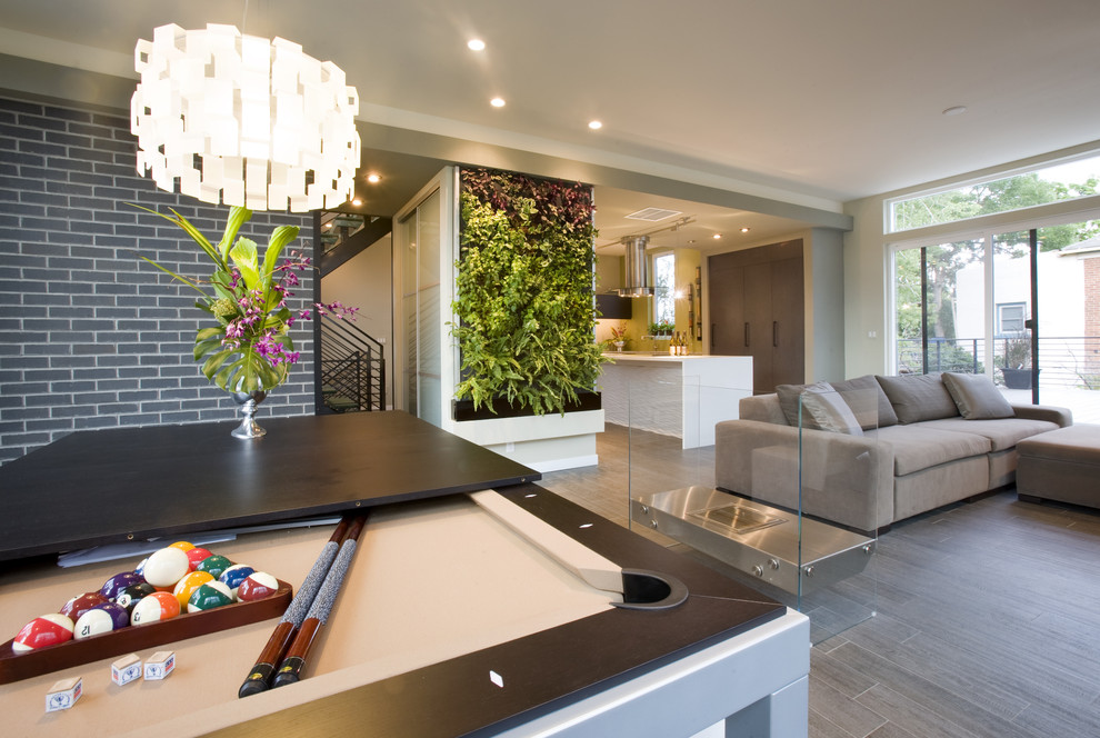 Family room - contemporary open concept gray floor and dark wood floor family room idea in Denver with beige walls and a two-sided fireplace