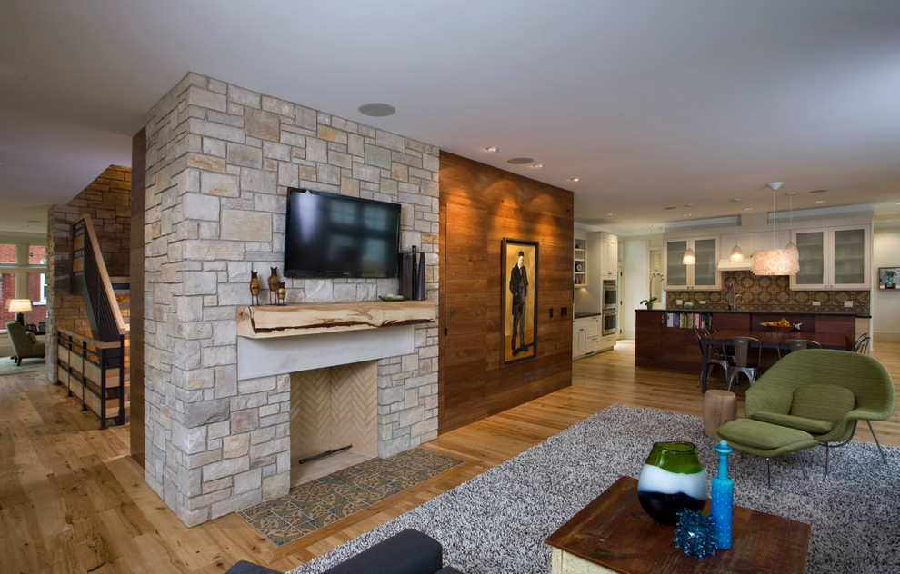 Inspiration for a medium sized classic open plan games room in Chicago with grey walls, light hardwood flooring, a standard fireplace, a stone fireplace surround and a wall mounted tv.