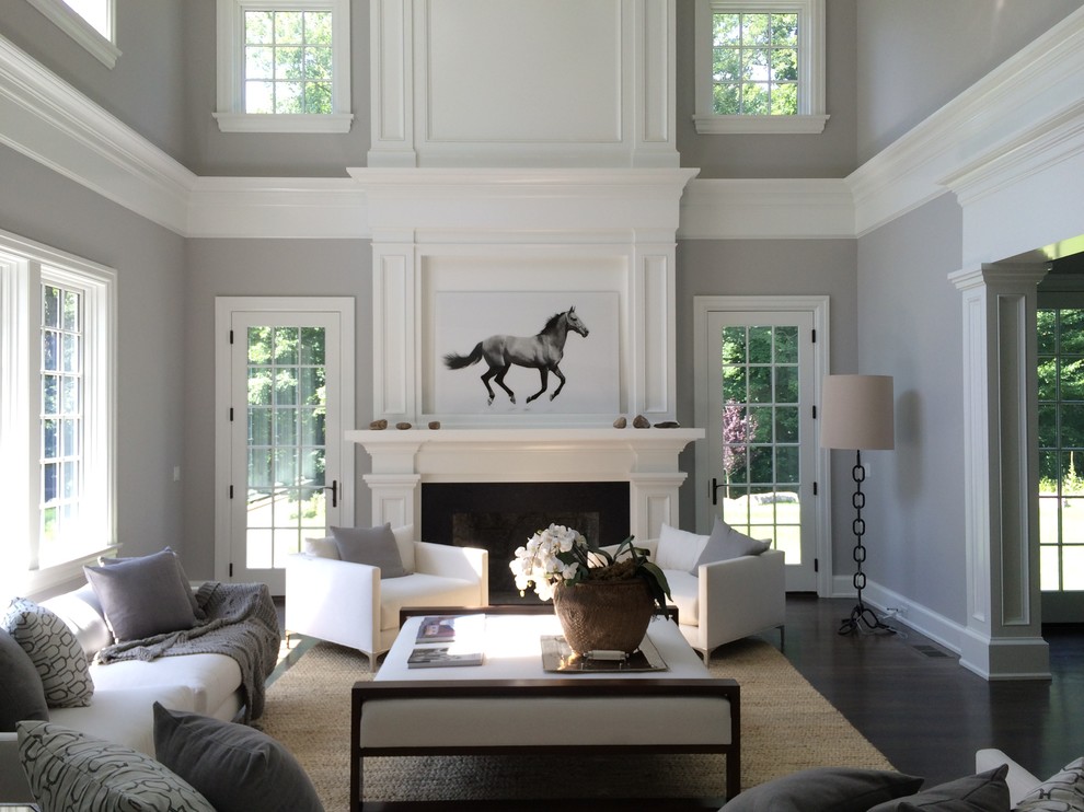 Inspiration for a large transitional open concept dark wood floor and brown floor family room remodel in Other with gray walls, a standard fireplace, a wood fireplace surround and no tv