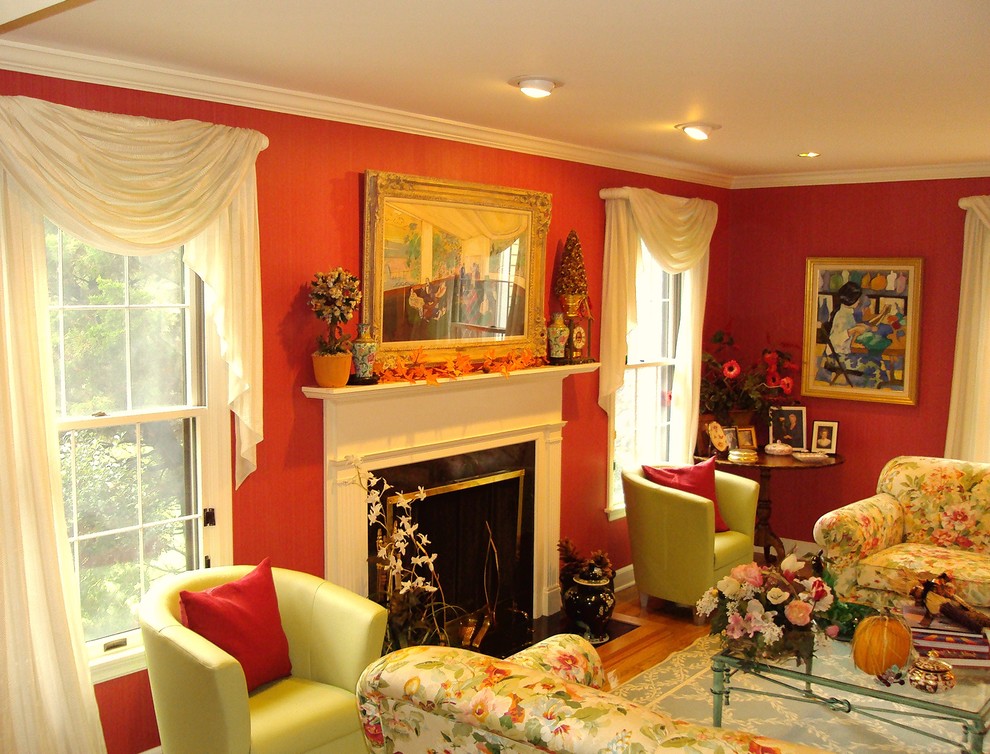 Inspiration for a mid-sized timeless open concept medium tone wood floor and brown floor family room remodel in New York with red walls, a standard fireplace, a wood fireplace surround and no tv