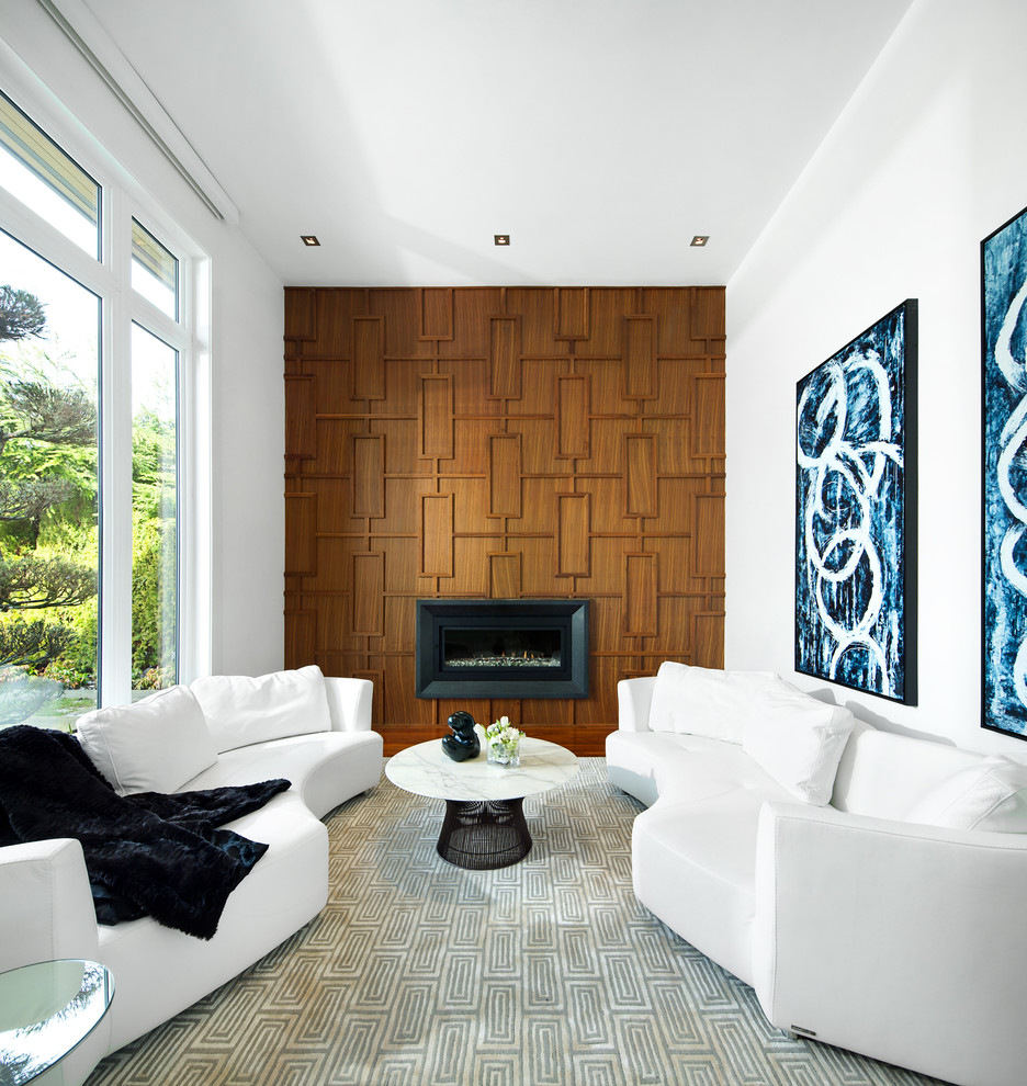 This is an example of a contemporary games room in Vancouver with white walls, a ribbon fireplace and a wooden fireplace surround.