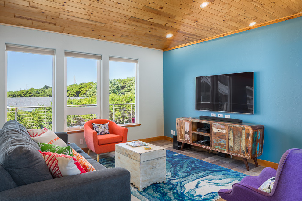 Inspiration for a mid-sized coastal loft-style laminate floor and multicolored floor family room remodel in Houston with blue walls