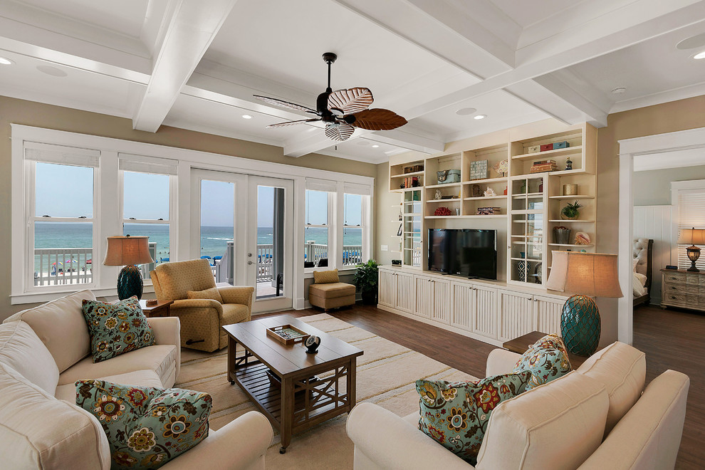 Design ideas for a medium sized beach style open plan games room in Miami with beige walls, medium hardwood flooring, no fireplace, a freestanding tv and brown floors.