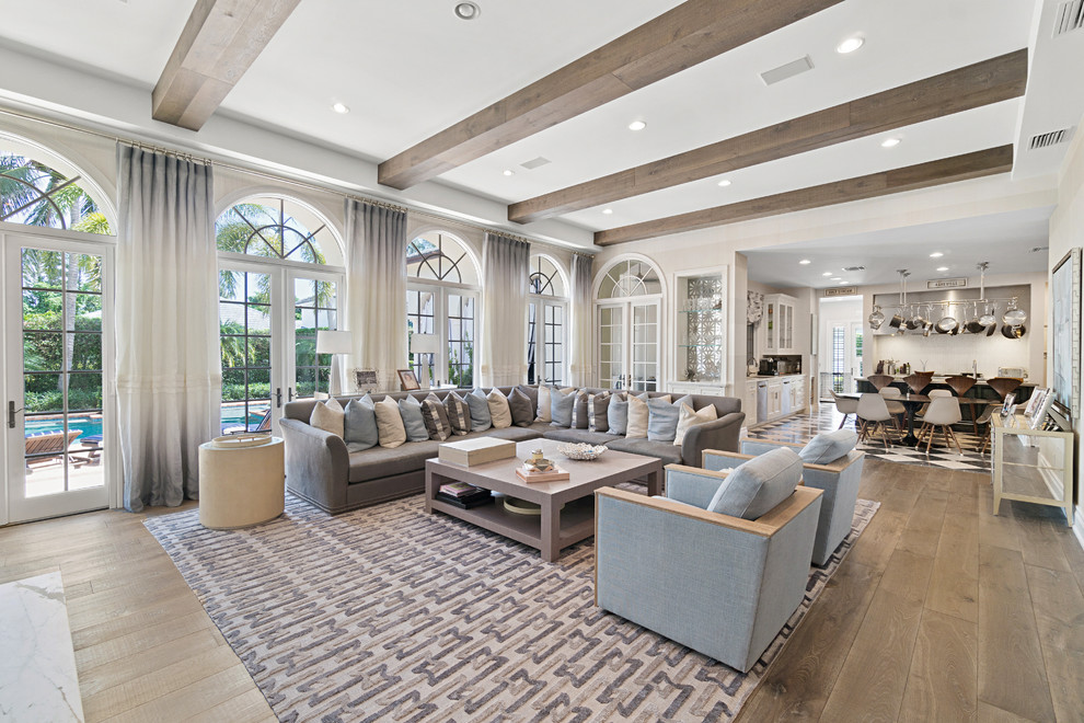 Inspiration for a large contemporary open plan games room in Miami with white walls, brown floors, exposed beams and dark hardwood flooring.