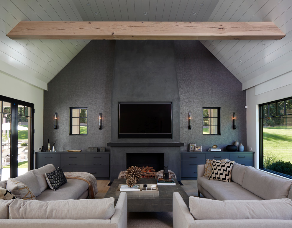 This is an example of a contemporary games room in New York with grey walls, a standard fireplace and a wall mounted tv.