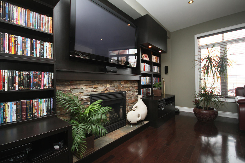 Large transitional open concept dark wood floor and brown floor family room photo in Toronto with a music area, gray walls, a hanging fireplace, a stone fireplace and a wall-mounted tv