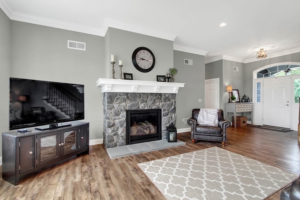Medium sized traditional open plan games room in Other with grey walls, vinyl flooring, a standard fireplace, a stone fireplace surround and a corner tv.
