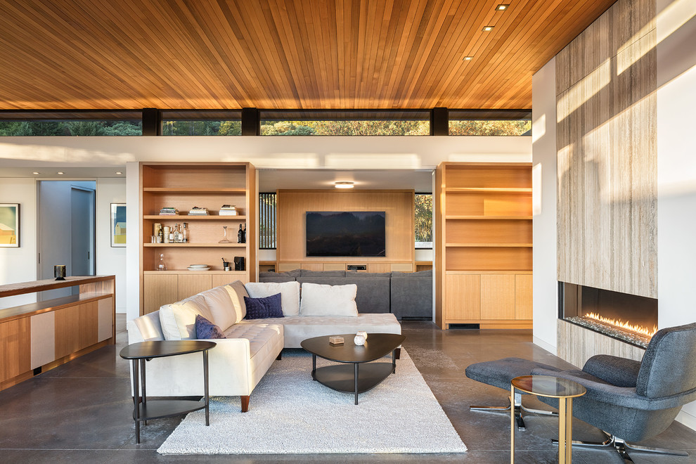 Contemporary open plan living room in San Francisco with white walls, concrete flooring, a ribbon fireplace and a wall mounted tv.