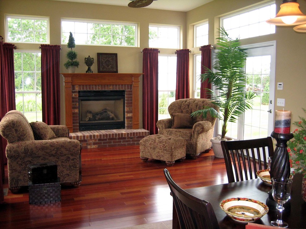 Inspiration for a mid-sized timeless open concept dark wood floor family room remodel in St Louis with beige walls, a ribbon fireplace, a brick fireplace and no tv