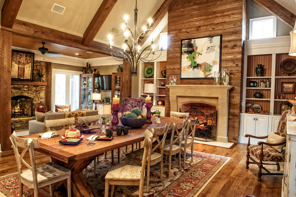 This is an example of a large rustic enclosed games room in Other with a standard fireplace, a stone fireplace surround, beige walls, medium hardwood flooring and brown floors.