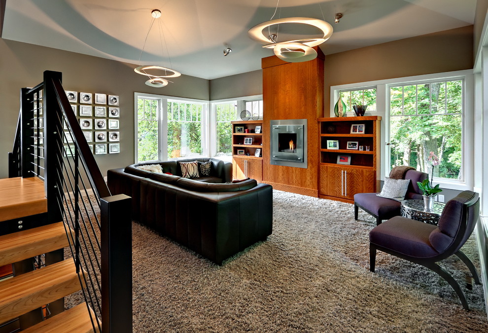 This is an example of a contemporary games room in Minneapolis with beige walls, carpet, a standard fireplace and a metal fireplace surround.