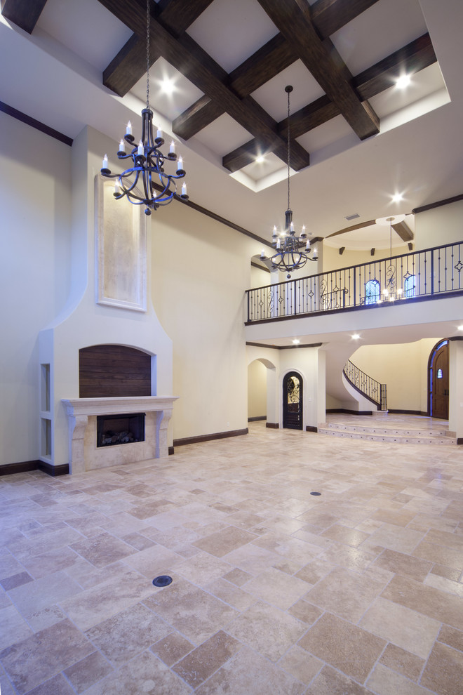 This is an example of an expansive mediterranean open plan games room in Orlando with white walls, travertine flooring, a standard fireplace, a metal fireplace surround and a wall mounted tv.