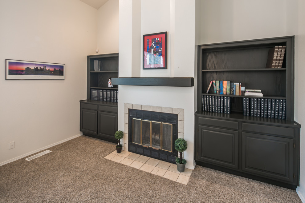 Large traditional open plan games room in Albuquerque with a reading nook, white walls, carpet, a standard fireplace, a tiled fireplace surround and a freestanding tv.