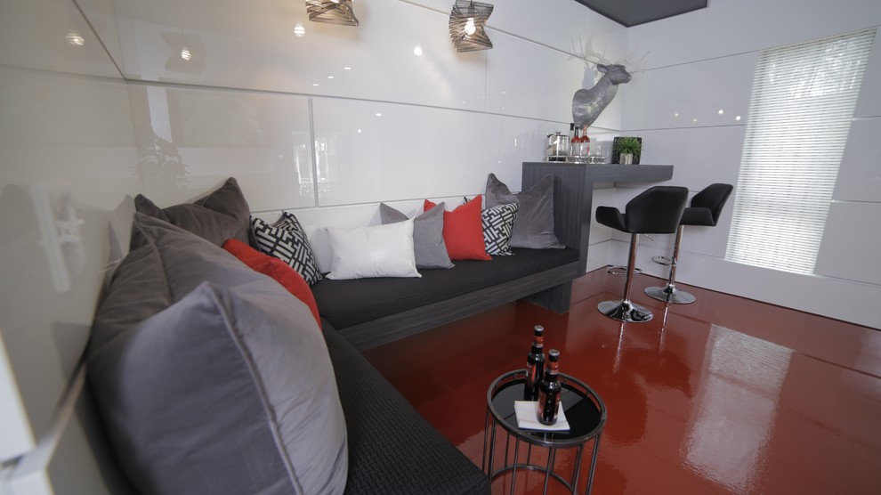 Esempio di un soggiorno moderno con angolo bar e pareti bianche