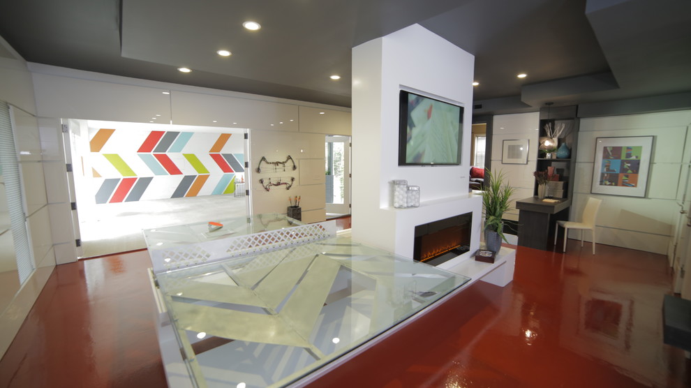 This is an example of a modern games room in Denver with a game room, white walls, a ribbon fireplace and a wall mounted tv.