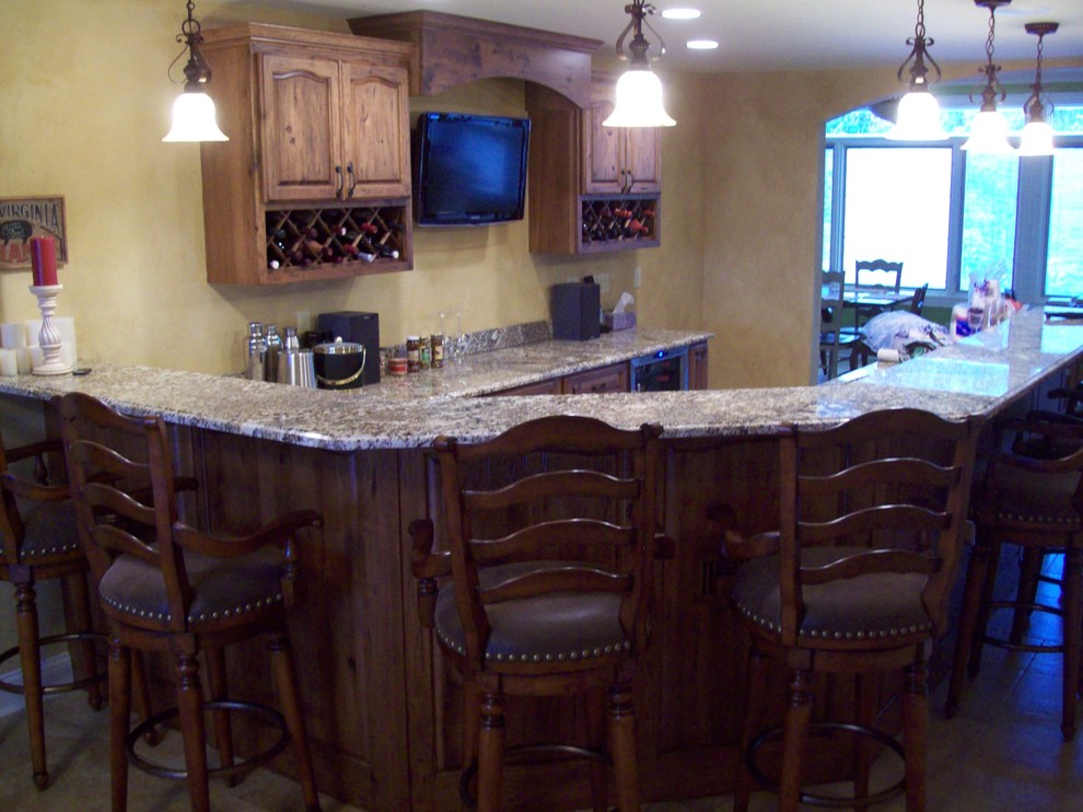 This is an example of a large farmhouse open plan games room in St Louis with a home bar, beige walls, ceramic flooring and a wall mounted tv.