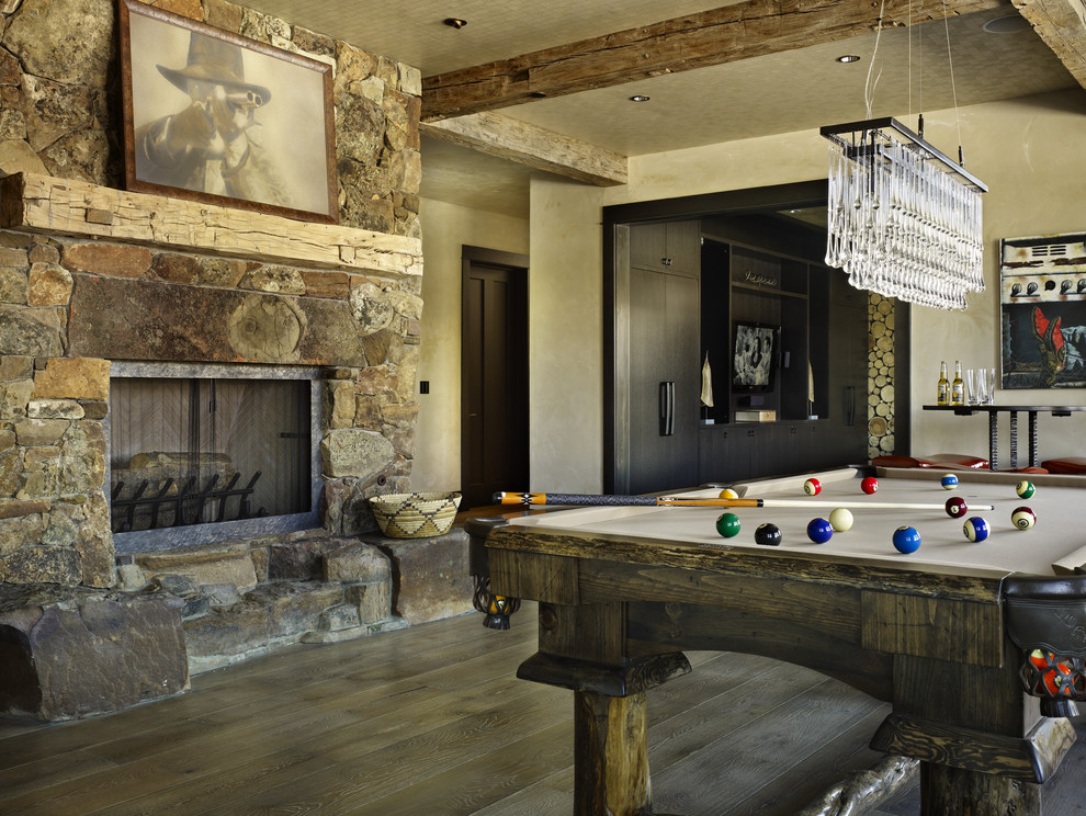 Mountain style family room photo in Denver with beige walls, a standard fireplace and a stone fireplace