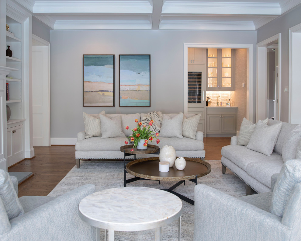 На фото: гостиная комната в стиле неоклассика (современная классика) с серыми стенами, паркетным полом среднего тона, коричневым полом и кессонным потолком