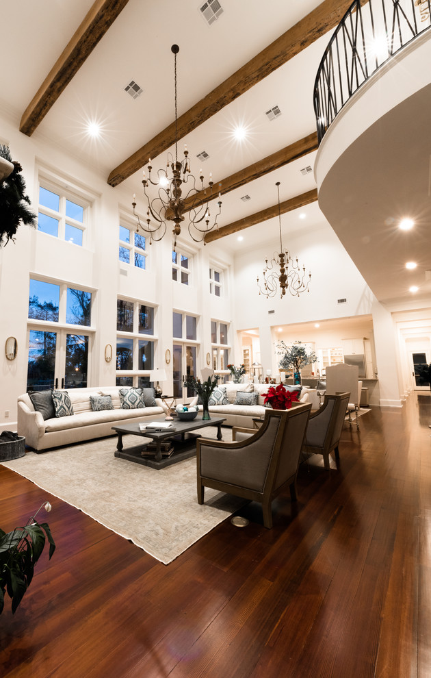Inspiration for a large classic open plan games room in New Orleans with white walls, a standard fireplace, no tv, dark hardwood flooring and brown floors.