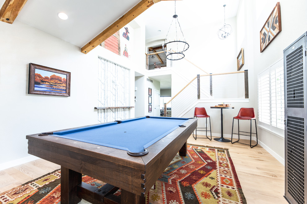 Photo of a traditional games room in Denver with white walls, light hardwood flooring and no tv.