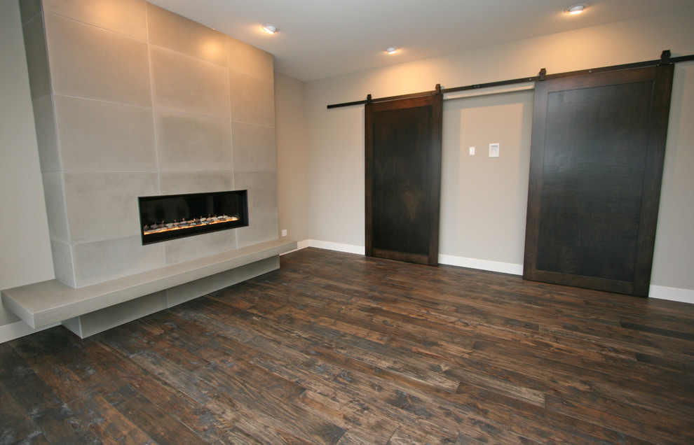 Example of a mid-sized trendy open concept medium tone wood floor family room design in Seattle with gray walls, a ribbon fireplace and a concealed tv