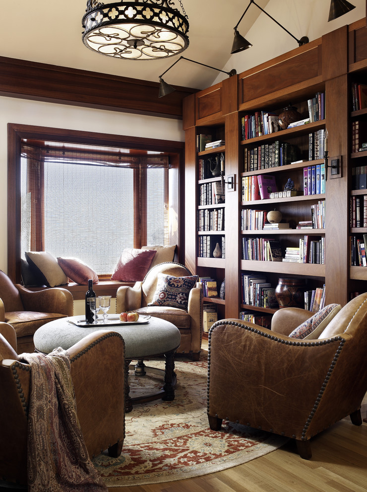 Example of a classic family room library design in San Diego