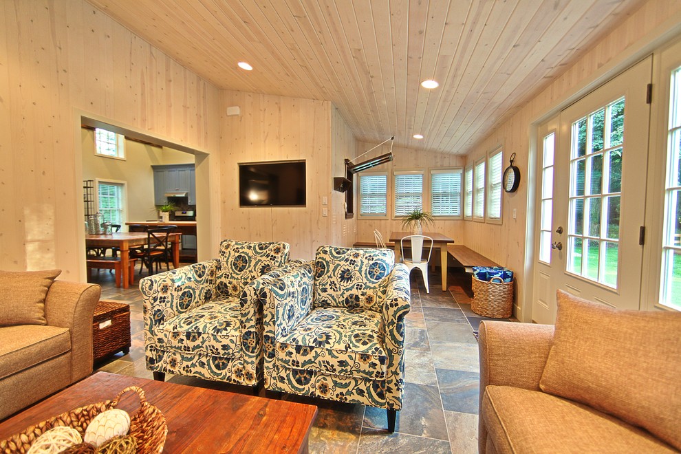 Example of a small beach style open concept slate floor family room design in Grand Rapids with beige walls, no fireplace and a wall-mounted tv
