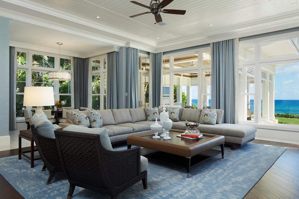 Expansive nautical open plan games room in Miami with blue walls and dark hardwood flooring.
