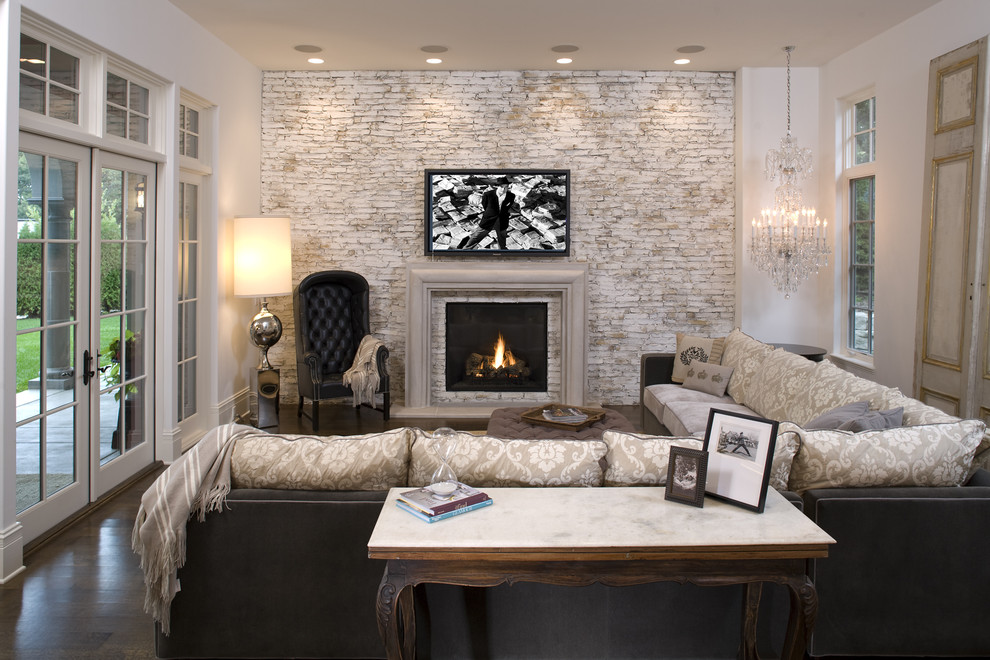 Example of a tuscan family room design in Minneapolis with a brick fireplace