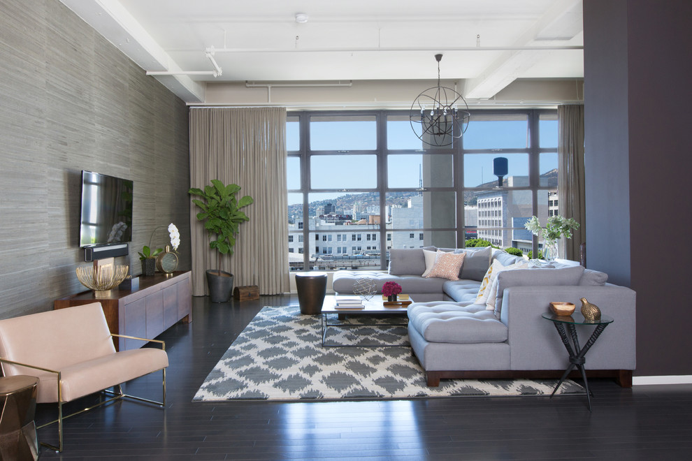 Inspiration for a mid-sized industrial dark wood floor family room remodel in Los Angeles with gray walls, no fireplace and a wall-mounted tv